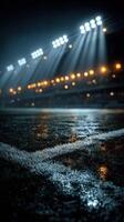 Nighttime football game under floodlights with rain-soaked pitch and dramatic lighting photo