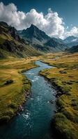 Majestic mountain landscape with a winding river flowing through lush green valley under a dramatic sky photo