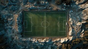 Unique soccer field nestled among rocky landscapes in a remote location during daylight hours photo