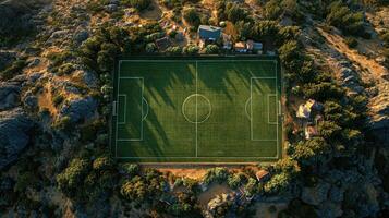 Expansive soccer field surrounded by nature in a serene location during sunset photo