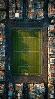 Fans gather around a vibrant soccer field in a lively urban setting during a weekend match in the afternoon photo