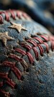Weathered baseball with red stitching and stars, highlighting the texture and character of the sport equipment photo