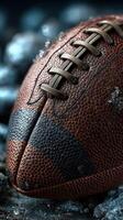 Close-up view of a weathered football resting on rocky ground in a dynamic sports setting photo