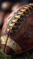 Vintage football resting on green grass at dusk with blurred balls in background photo