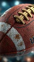 Close-up view of a textured brown football with laces placed on a background featuring blurred colors and lights photo
