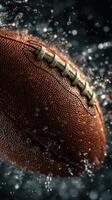 Football splashes through water droplets, showcasing texture and motion in a dynamic indoor setting photo