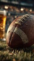Football resting on grass beside a cold drink during an exciting game day atmosphere at a sports field photo