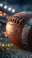 Football resting on grass with stadium lights in the background during a game night photo
