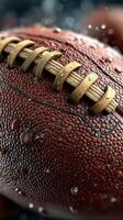 Close-up view of a wet football highlighting its texture and details during a rainy game at a local field photo