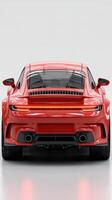Red sports car parked in a bright studio setting showcasing its sleek design and modern features photo