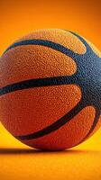 Brightly colored basketball resting on an orange background, showcasing texture and detail during playtime photo