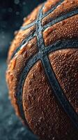 Close up view of a wet basketball showcasing its textured surface and droplets against a dark background photo