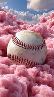 Baseball resting on fluffy pink clouds under a blue sky with soft white clouds in the background photo
