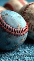 Weathered baseballs resting on a blue surface highlight the essence of sports and teamwork in a playful atmosphere photo