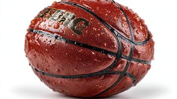 Wet basketball resting on a surface with droplets glistening under bright light photo