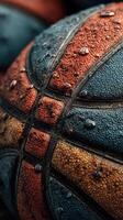 Detailed close-up of weathered basketballs resting on each other after a fresh rain in a sports court photo