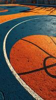Colorful basketball court featuring vibrant orange and blue paint at a community park during sunny afternoon photo