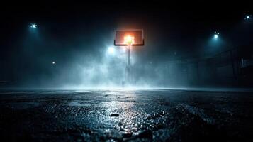 Basketball hoop illuminated at night surrounded by mist on an empty court photo