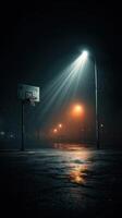 Basketball court illuminated by streetlights in foggy night setting photo