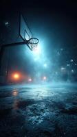 Nighttime basketball court illuminated by fog and streetlights in an urban setting photo