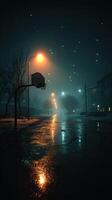 Nighttime street with a basketball hoop illuminated by streetlights in a quiet neighborhood photo