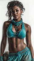 Female athlete poses confidently with a soccer ball while wearing sporty teal attire in a creatively lit studio setting photo