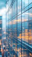 City skyline at dusk with reflections on a modern glass building showcasing vibrant urban lights photo