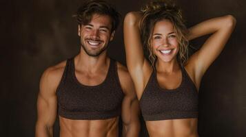 Couple showcases fitness achievements with smiles in a dimly lit studio during a photoshoot photo