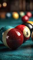 Close-up view of billiard balls resting on a teal surface during a game night with friends at a local pool hall photo