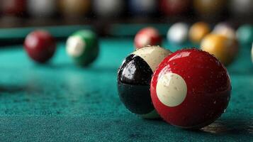 Focus on red and black pool balls resting on a blue felt table during a casual game photo