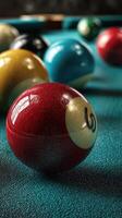 Colorful billiard balls on a green felt pool table highlighted by soft lighting in a cozy game room photo