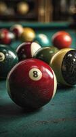 Eight ball and other billiard balls arranged on the green felt surface at a pool hall during an evening game photo