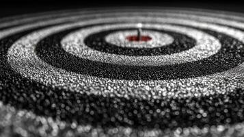 Target with concentric circles in black and silver highlighting the central focus point at a close range shot photo