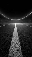 Stadium view from the ground perspective showcasing the track and seating area under bright lights at night photo