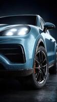 Sleek blue car with raindrops showcases modern design in moody lighting at a studio setting photo