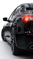 Sleek black luxury car parked in a modern indoor showroom with reflections on the surface photo