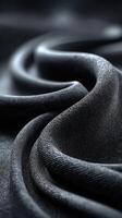 Textured black fabric draping gracefully over a surface in a soft, elegant manner photo