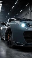 Luxury sports car parked inside an industrial garage during evening hours with dramatic lighting photo