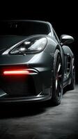 Sleek gray sports car showcased in dramatic lighting with focused details on wheels and front markings photo