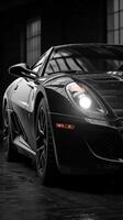Sleek black sports car gleams under industrial lighting in a warehouse setting during a rainy evening photo