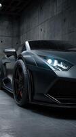 Sleek black sports car parked in an industrial garage with rain droplets on its surface photo
