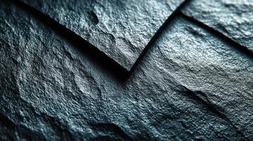 Textured dark surface showcasing natural slate patterns with intricate details and variations in light during the afternoon photo