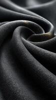Close-up view of elegant black fabric showcasing luxurious texture and smoothness in natural light photo