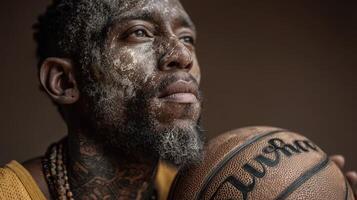 Basketball player with unique facial art holds ball, showcasing deep focus and determination in a studio setting photo