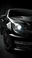 High-performance black luxury sedan showcased in a sleek studio setting at night with dramatic lighting and modern design elements photo