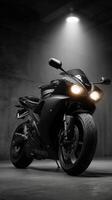 Black sports motorcycle under spotlight in an industrial setting at night showcasing sleek design and power photo