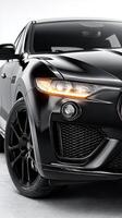 Sleek black sports car showcasing modern design and powerful features in a bright studio setting photo