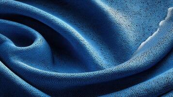 Textured blue fabric showcasing intricate patterns and soft folds in natural light during the day photo