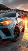 Luxury sports car parked at sunset, showcasing sleek design and modern features with a picturesque background photo