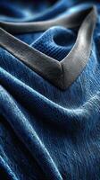 Textured blue fabric with dark trim showcasing intricate weaving and soft drape for design inspiration photo
